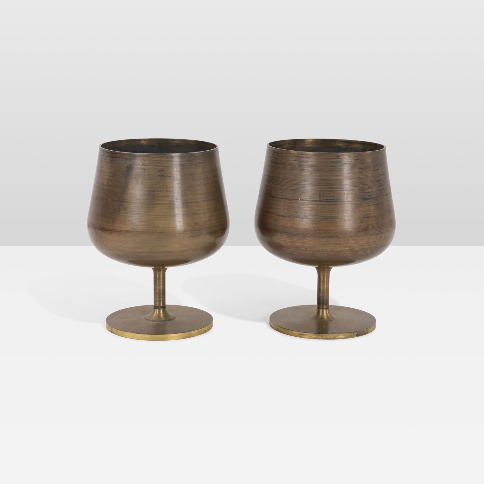 Florence Knoll - Brass Vases: A pair of turned brass vases by Florence Knoll. All measurements are in inches. Height x Width x Depth
