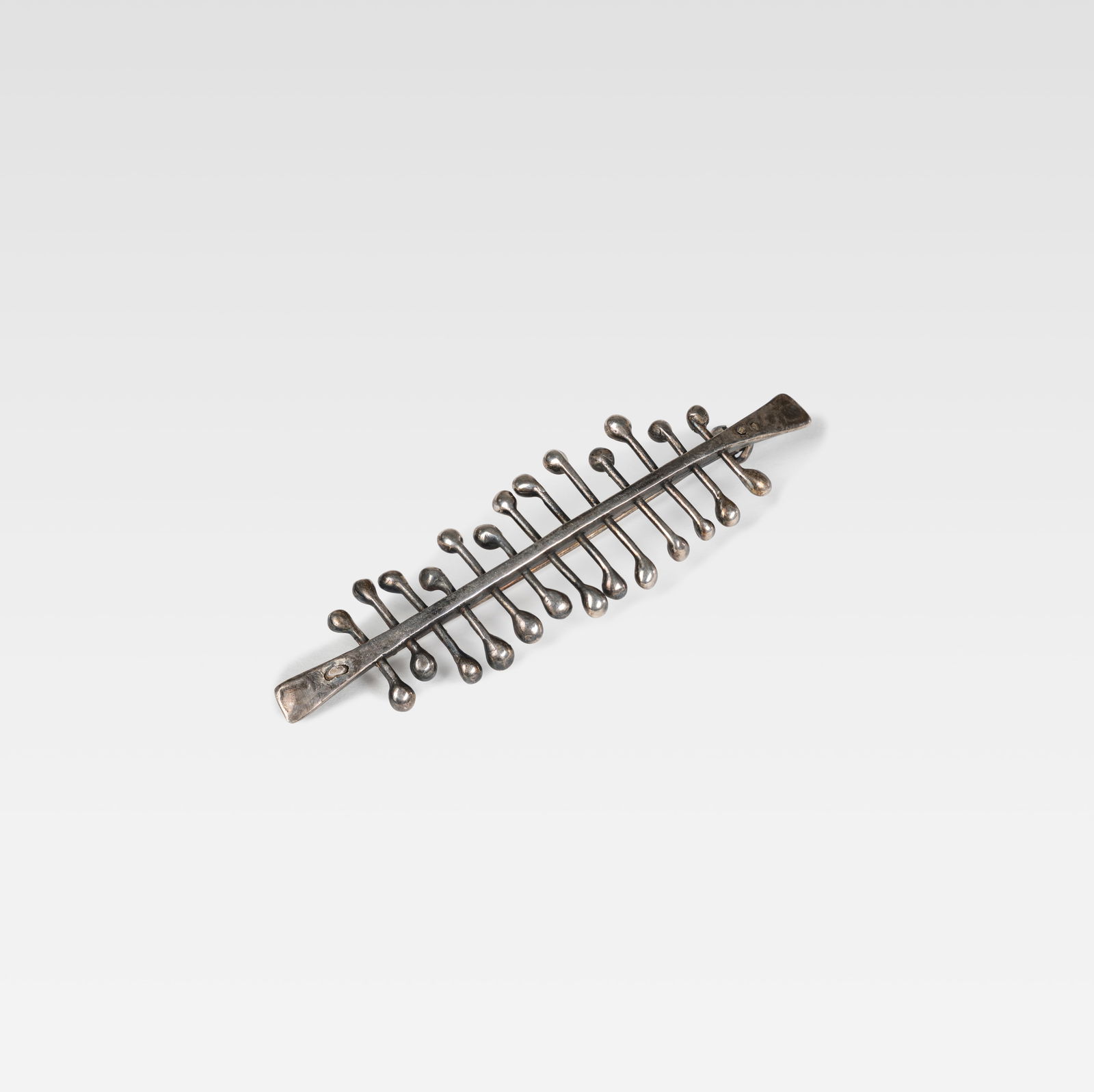 Harry Bertoia - Brooch: A reproduction sterling silver brooch by Harry Bertoia. With original box and paperwork. All measurements are in inches. Height x Width x Depth