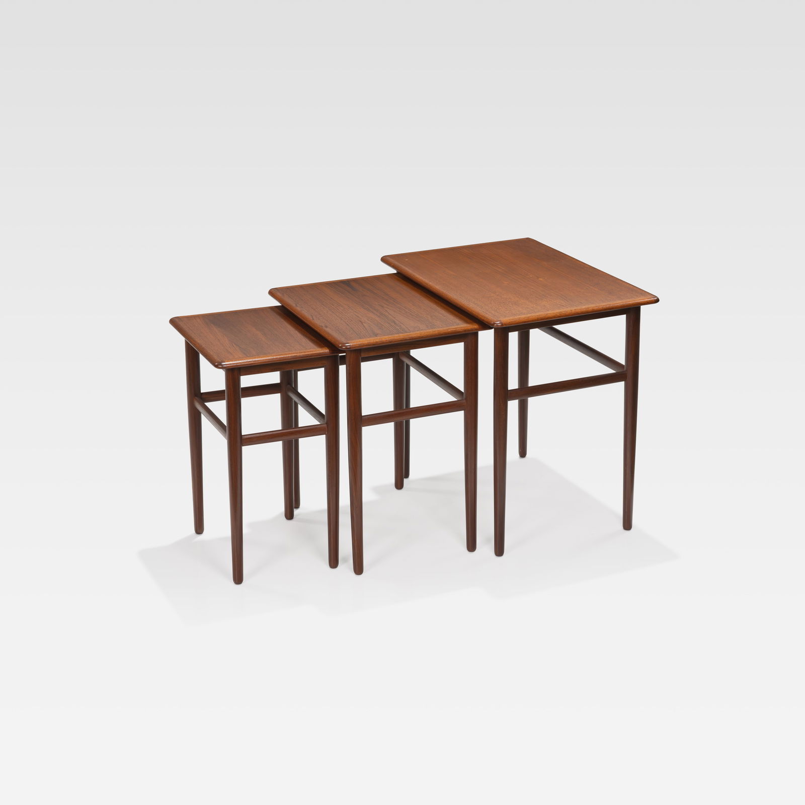 Danish Nesting Tables: A set of three Danish teak nesting tables. All measurements are in inches. Height x Width x Depth