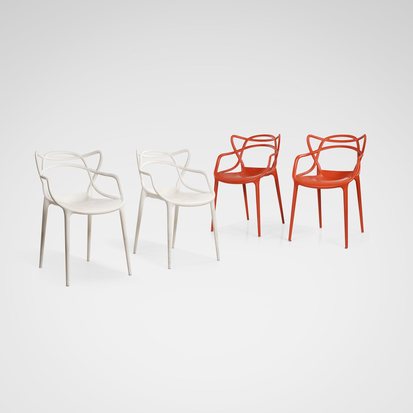 Philippe Starck - Masters Chairs: A set of four 'Masters' chairs by Philippe Starck for Kartell Italy. Two red, two white. All measurements are in inches. Height x Width x Depth