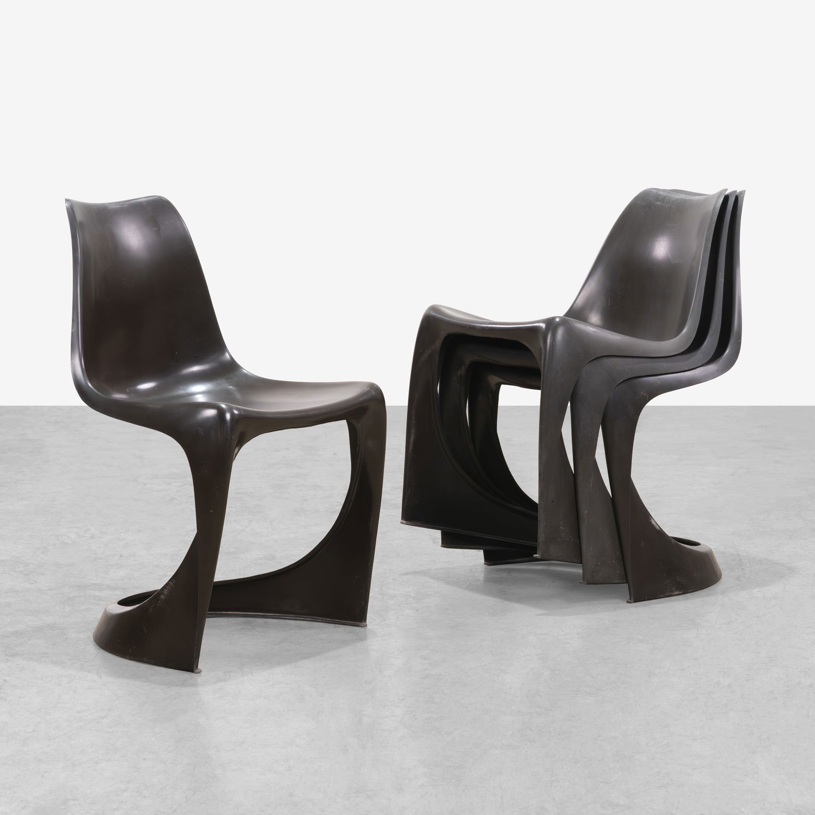 Steen Ostergaard - Chairs: A set of four Model 291 plastic stacking chairs by Steen Ostergaard for Cado. All measurements are in inches. Height x Width x Depth
