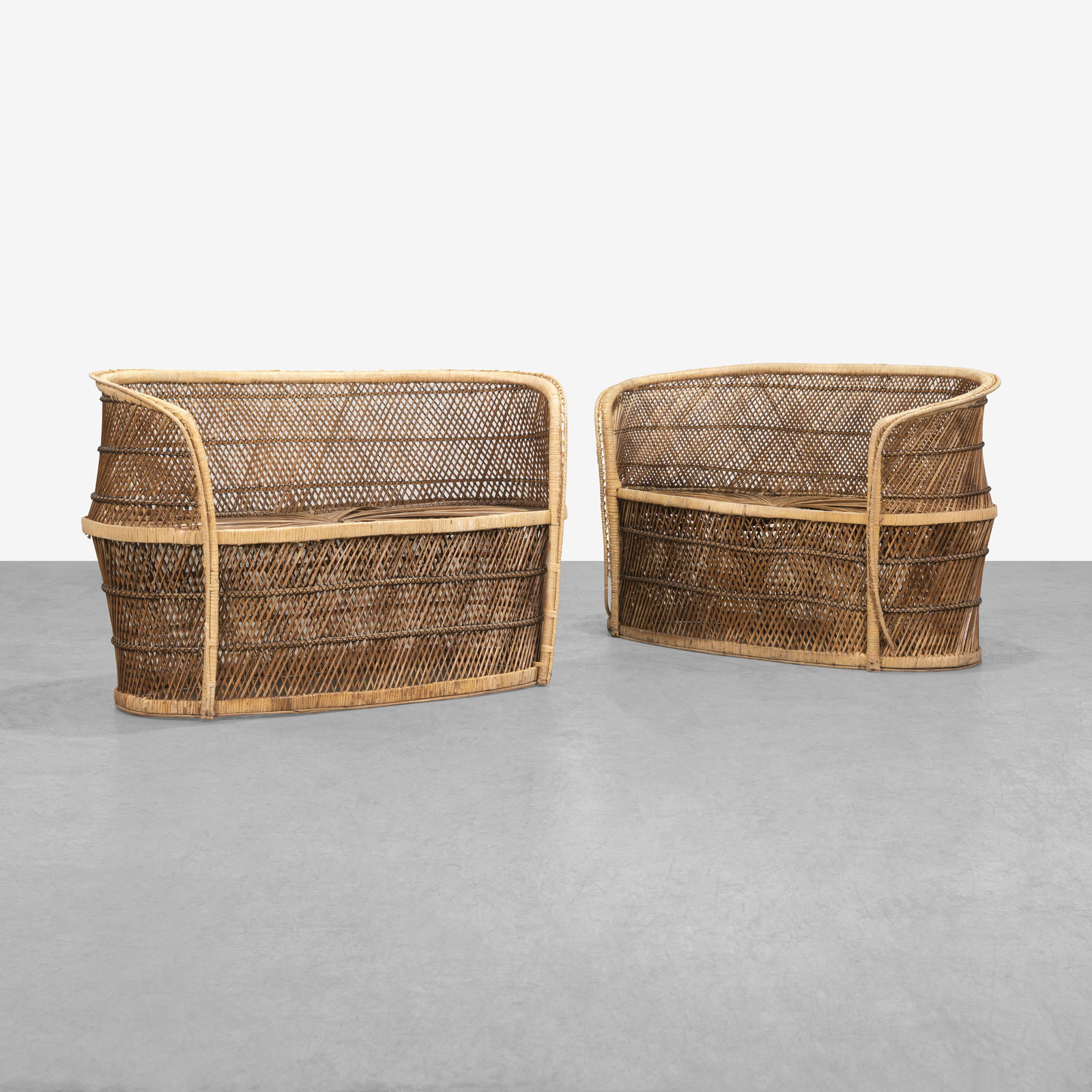 Rattan Settees: A pair of Boho style rattan settees. All measurements are in inches. Height x Width x Depth