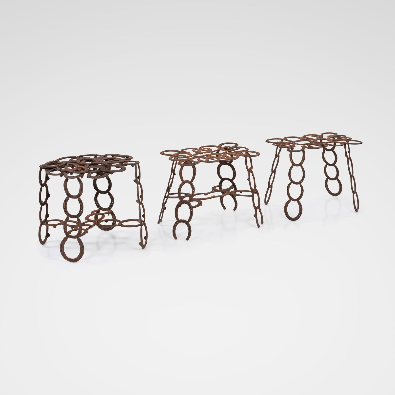 Horseshoe Tables: A set of three similar tables made of horseshoes. Dimensions listed are for the tallest table. All measurements are in inches. Height x Width x Depth