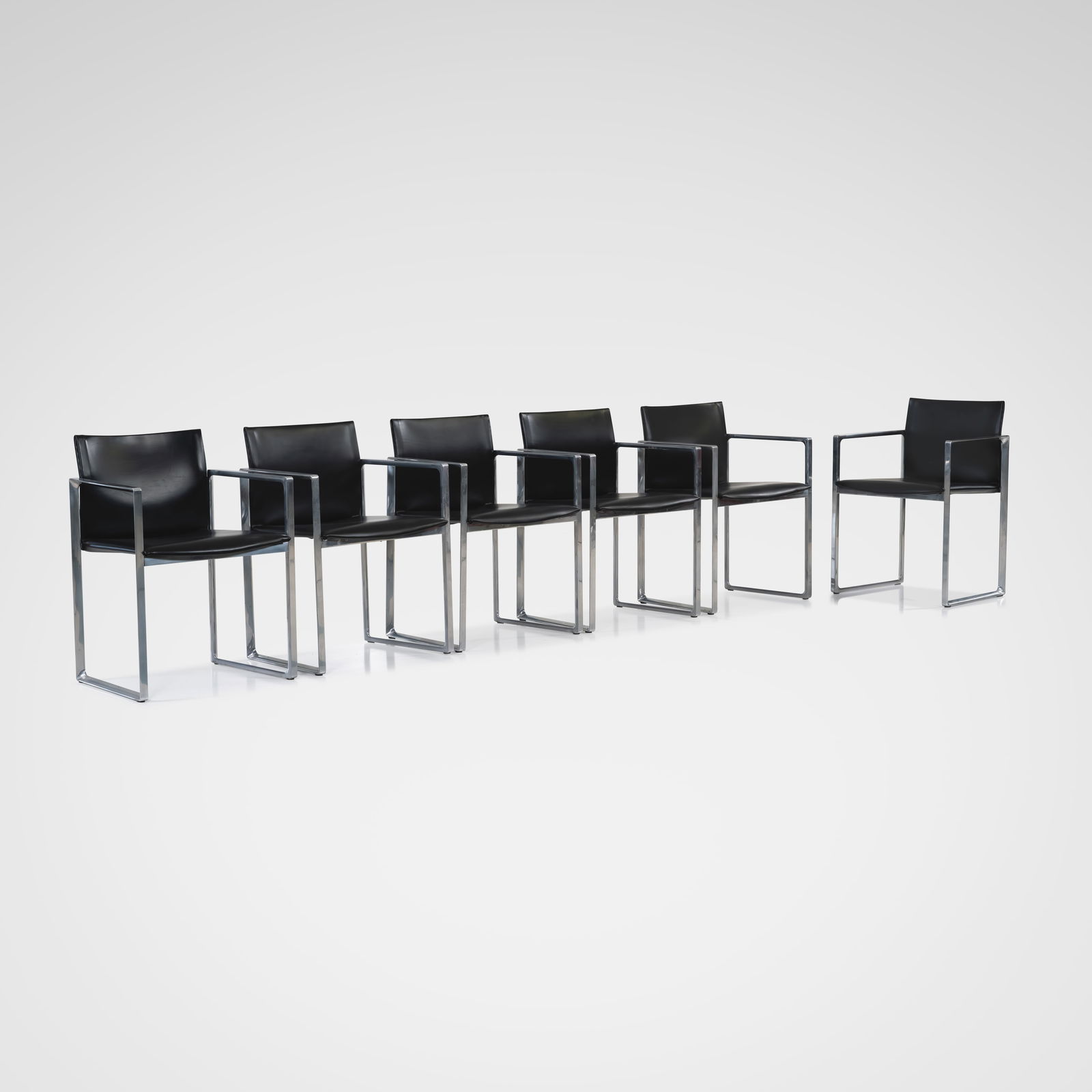 Piero Lissoni - Dining Chairs: A set of six 'Eve', Model 184, dining chairs by Piero Lissoni for Cassina, Italy in black leather and polished aluminum. All measurements are in inches. Height x Width x Depth