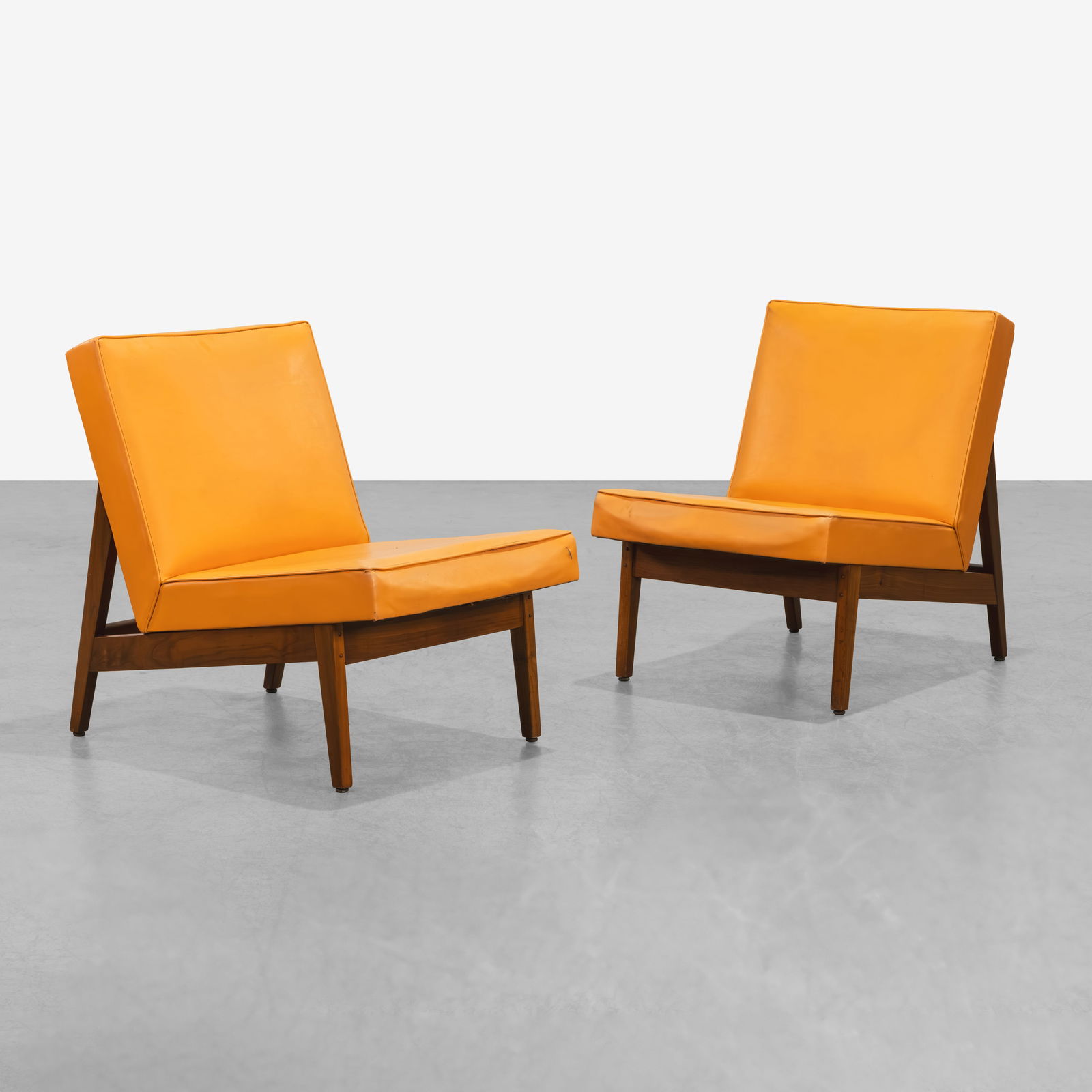 Vintage Slipper Chairs: A pair of vintage walnut slipper chairs in the manner of Florence Knoll. All measurements are in inches. Height x Width x Depth