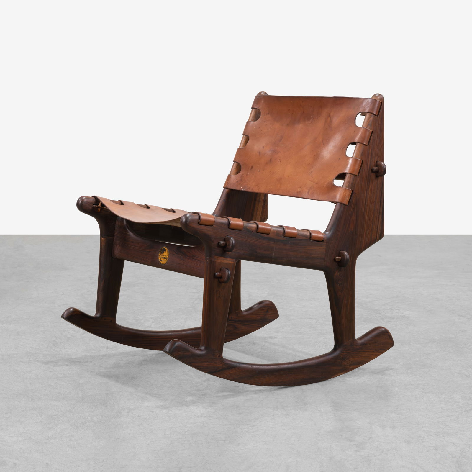 T. Caivinagua - Rocking Chair: A rosewood and leather sling rocking chair by T. Caivinagua in the manner of Angel Pazmino. All measurements are in inches. Height x Width x Depth