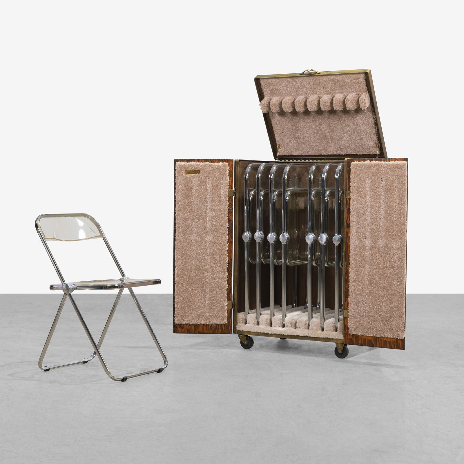 Giancarlo Piretti - Plia Chairs: A set of eight vintage 'Plia' chairs by Giancarlo Piretti for Anonima Castelli, Italy with custom made storage case on casters. Storage case dimensions - 41.5 x 30.5 x 21.25. All measurements are in