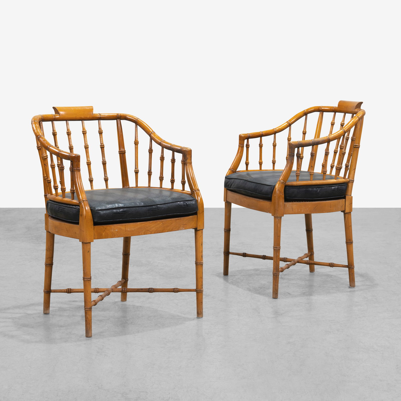 Faux Bamboo Arm Chairs: A pair of faux bamboo arm chairs with cane seats. All measurements are in inches. Height x Width x Depth