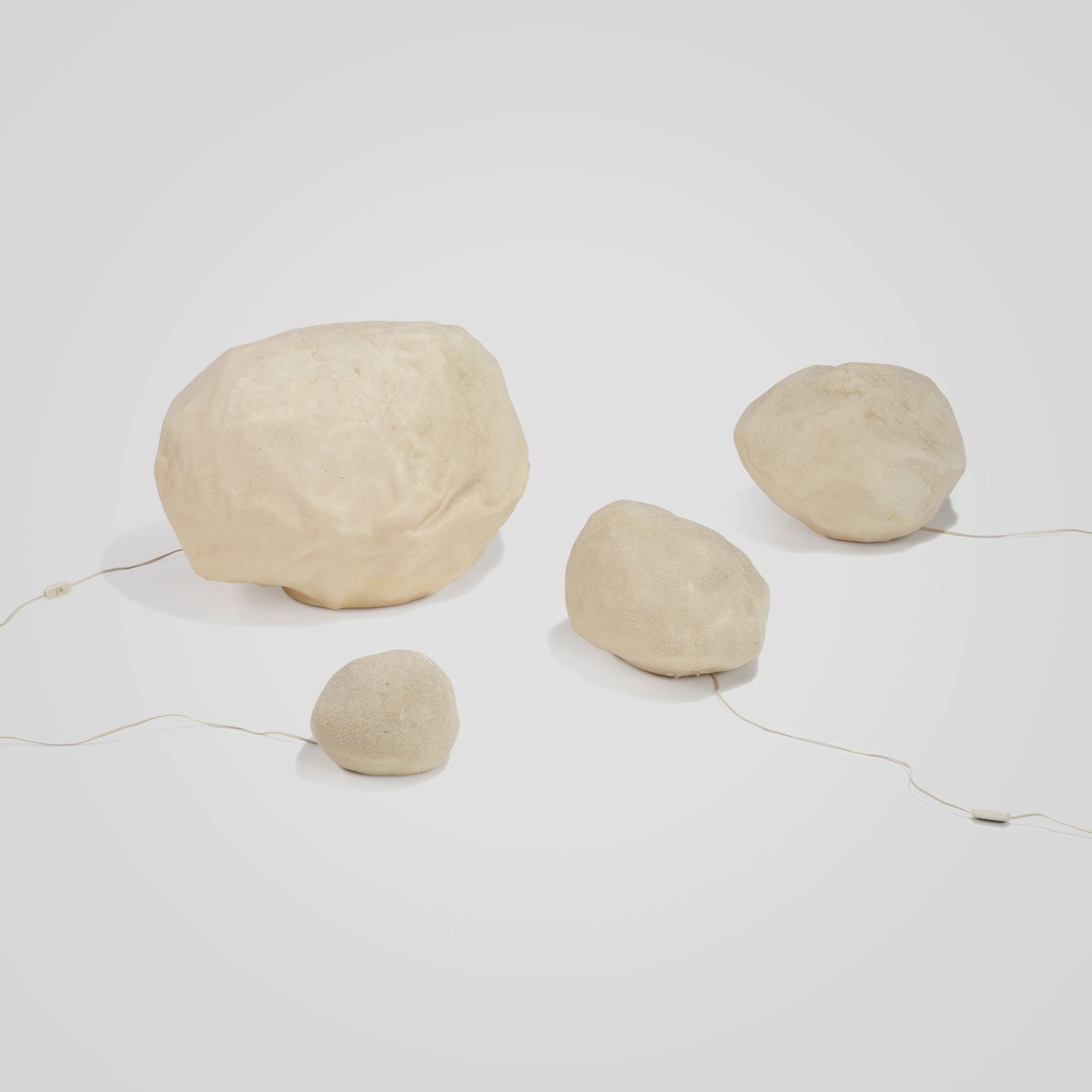 Moon Rock Lights: A set of four vintage 'Moon Rock' floor lights by Singletron, Italy. Dimensions listed are for the largest rock.