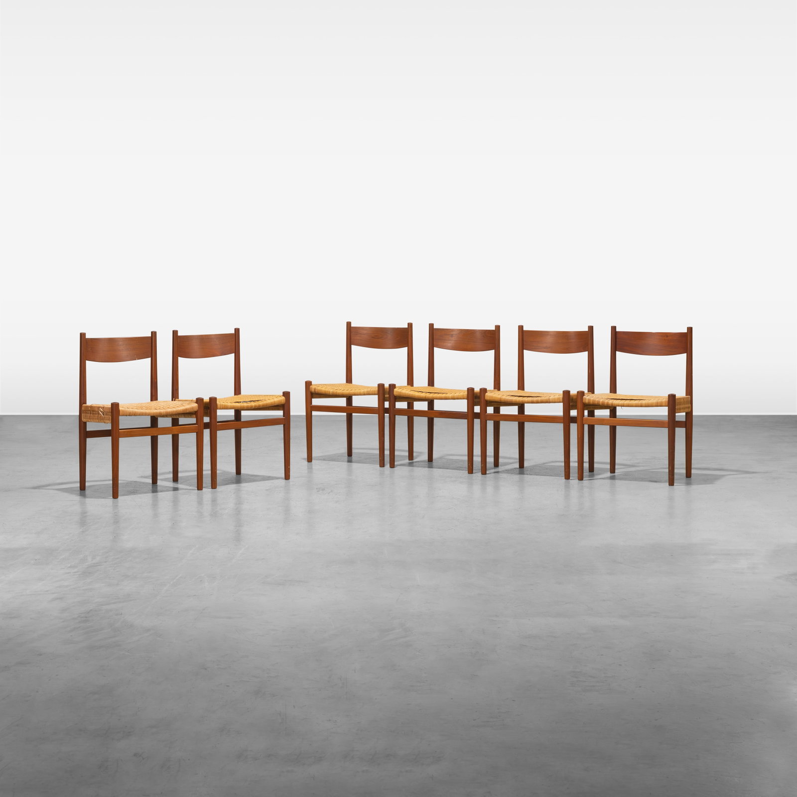 Hans Wegner - Dining Chairs: A set of six teak and cane 'CH40' dining chairs by Hans Wegner. All measurements are in inches. Height x Width x Depth