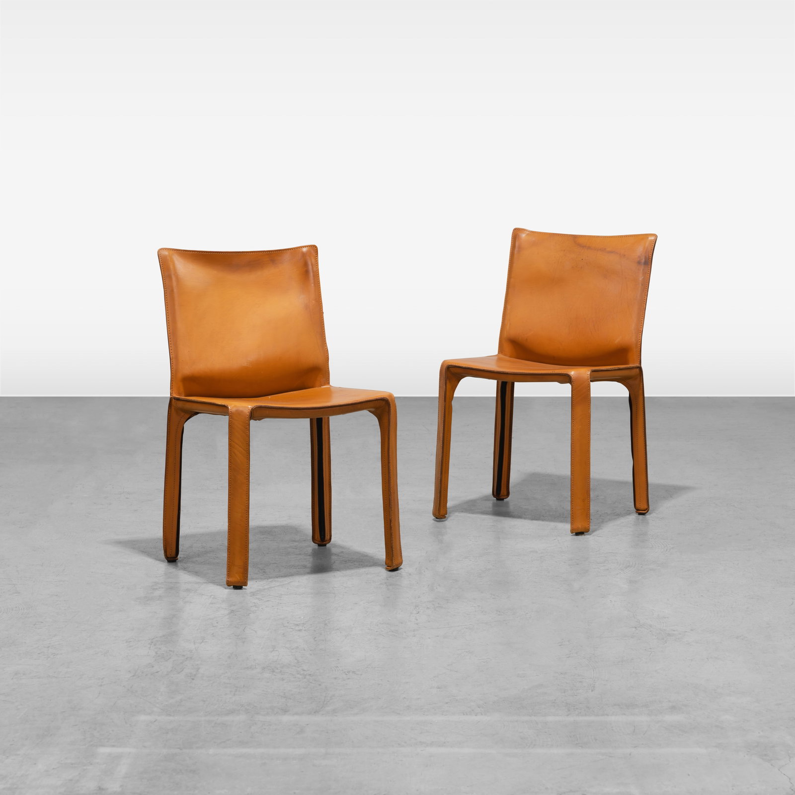 Mario Bellini - Cab Chairs: A pair of Cab chairs by Mario Bellini for Cassina, Italy. All measurements are in inches. Height x Width x Depth