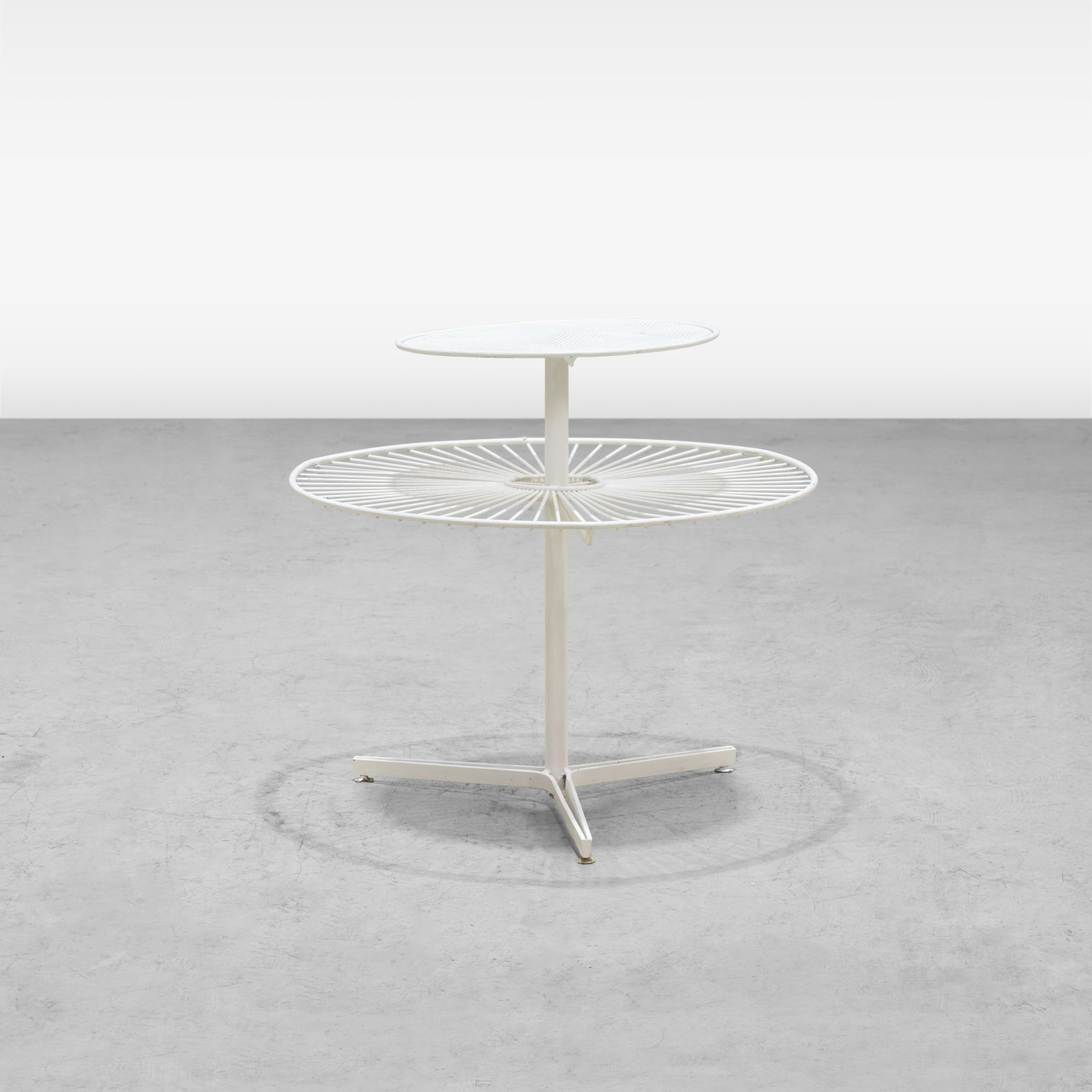 Vladimir Kagan - Capricorn Table: A two tier iron 'Capricorn' patio table by Vladimir Kagan. All measurements are in inches. Height x Width x Depth