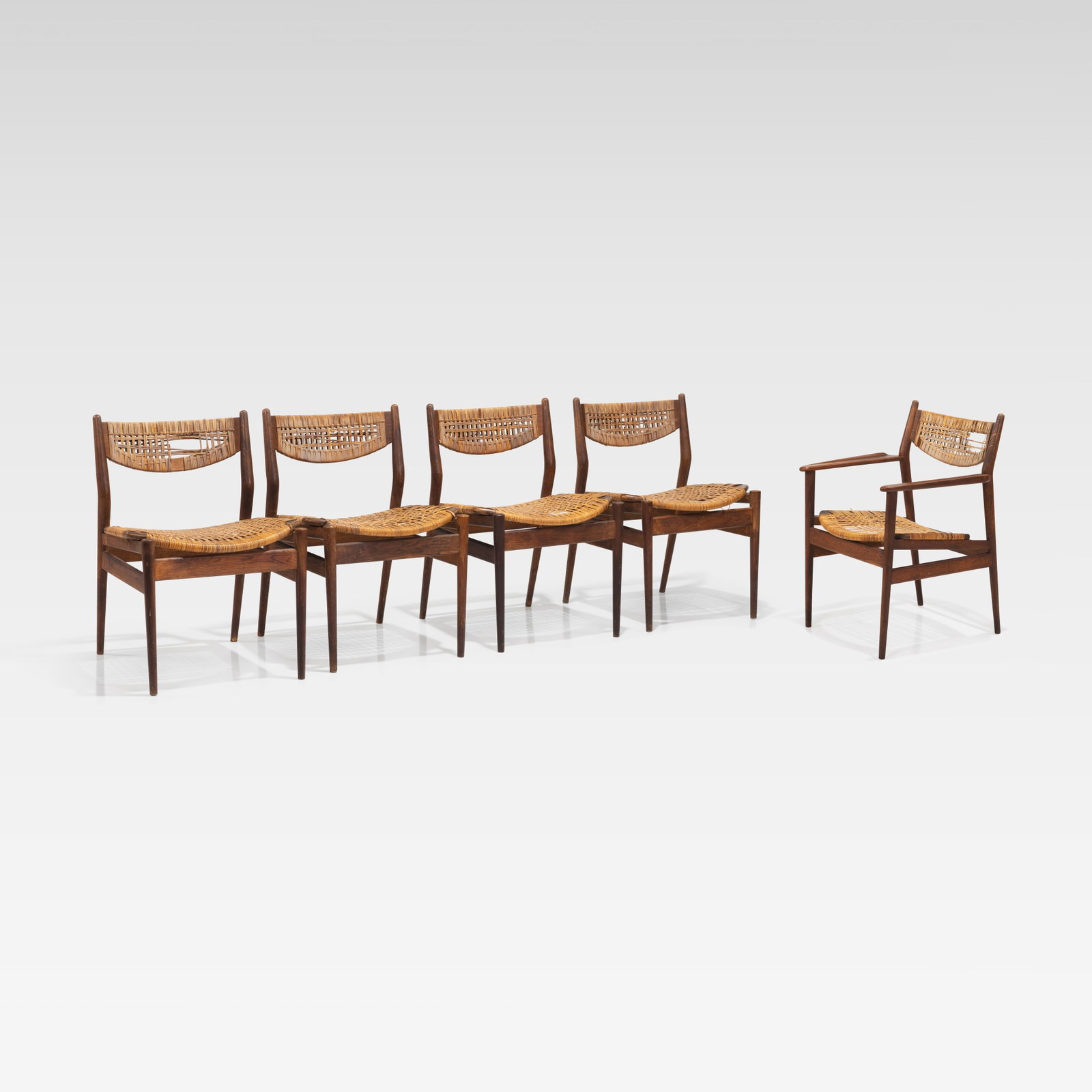 Arne Vodder - Dining Chairs: A set of five teak and cane dining chairs by Arne Vodder for Sibast, imported by George Tanier. All measurements are in inches. Height x Width x Depth