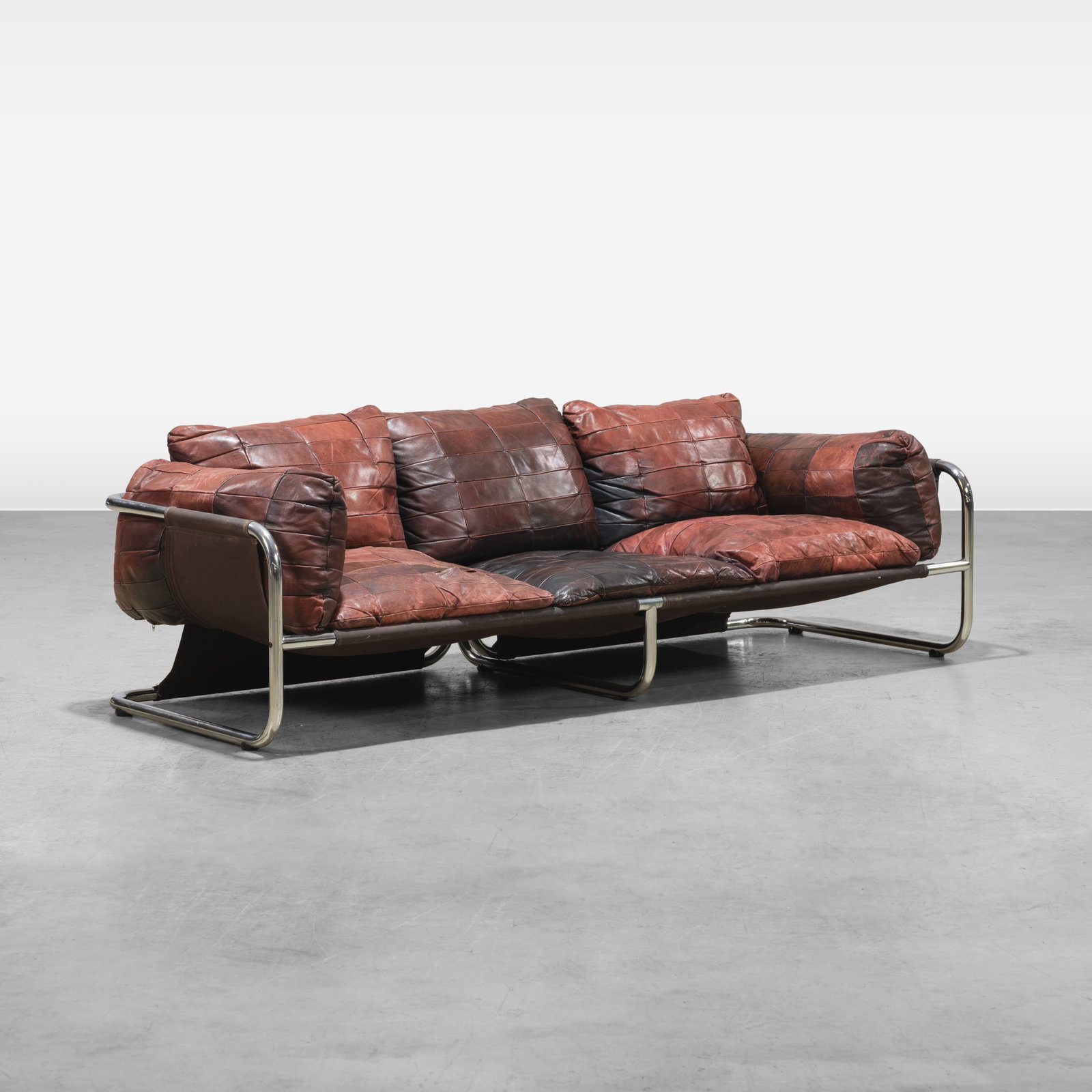 Patchwork Leather Sofa: Patchwork leather three seat sofa on chrome base All measurements are in inches. Height x Width x Depth
