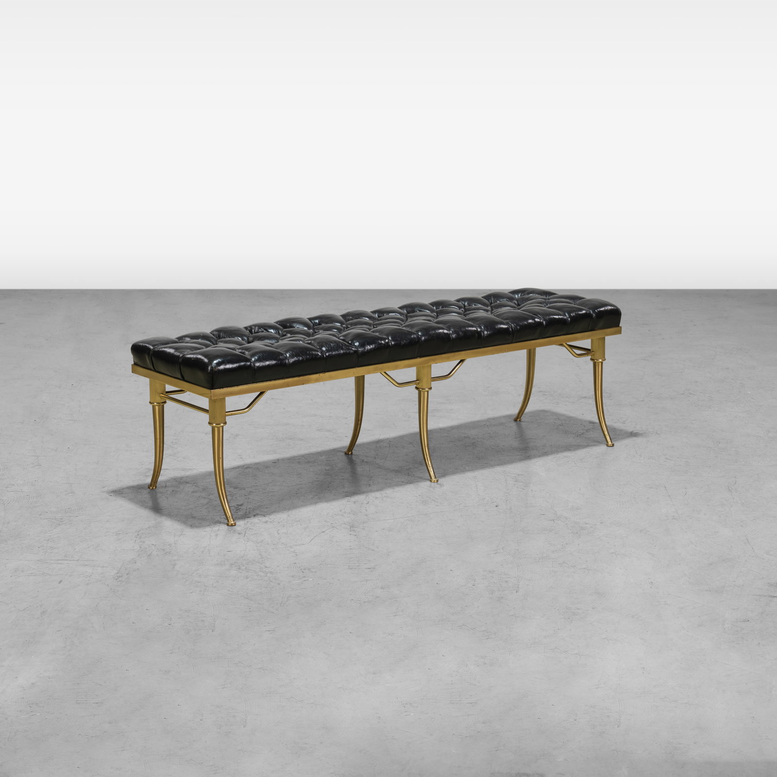 William "Billy" Haines - Bench: A brass and button tufted leather bench by William (Billy) Haines. All measurements are in inches. Height x Width x Depth