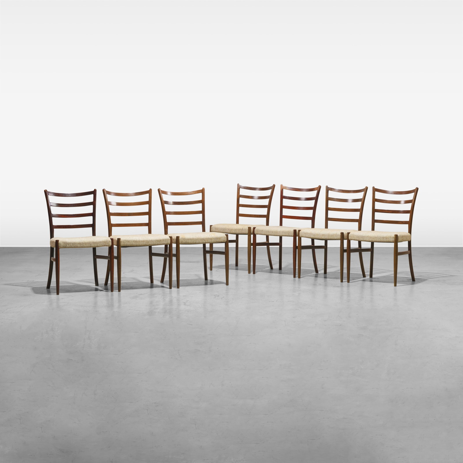 Danish Rosewood Dining Chairs: A set of seven Danish rosewood dining chairs. All measurements are in inches. Height x Width x Depth
