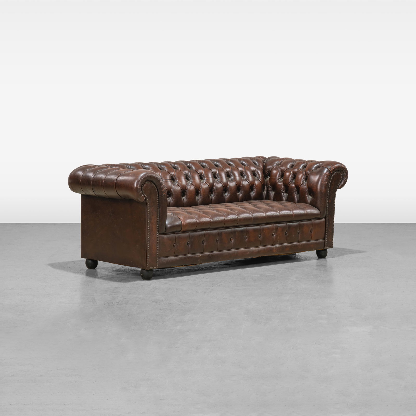 Leather Chesterfield Sofa: A tufted leather Chesterfield sofa. All measurements are in inches. Height x Width x Depth