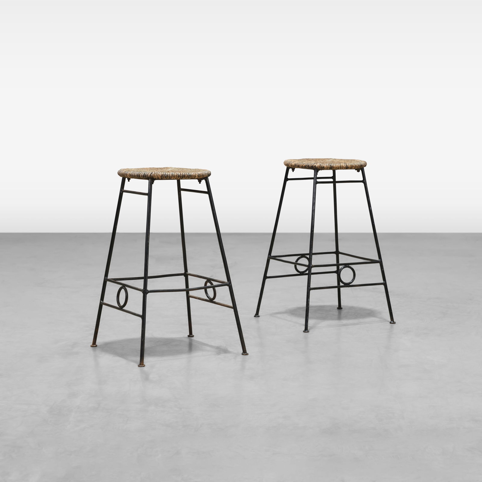 Iron Stools: A pair of vintage iron stools with cord seats. All measurements are in inches. Height x Width x Depth
