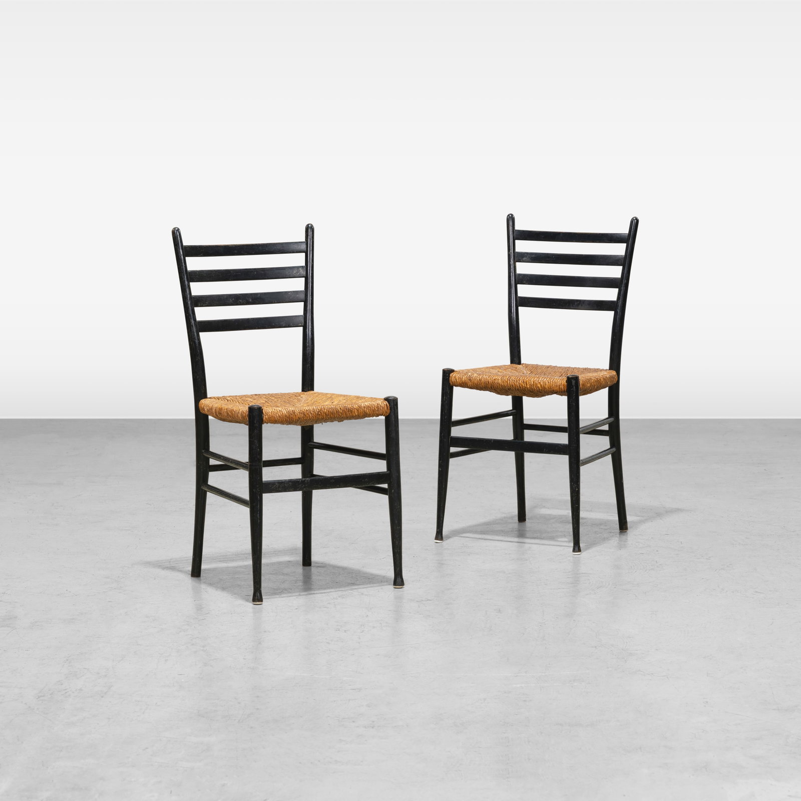 Italian Ladder Back Chairs: A pair of Italian ladderback chairs in the manner of Gio Ponti. All measurements are in inches. Height x Width x Depth