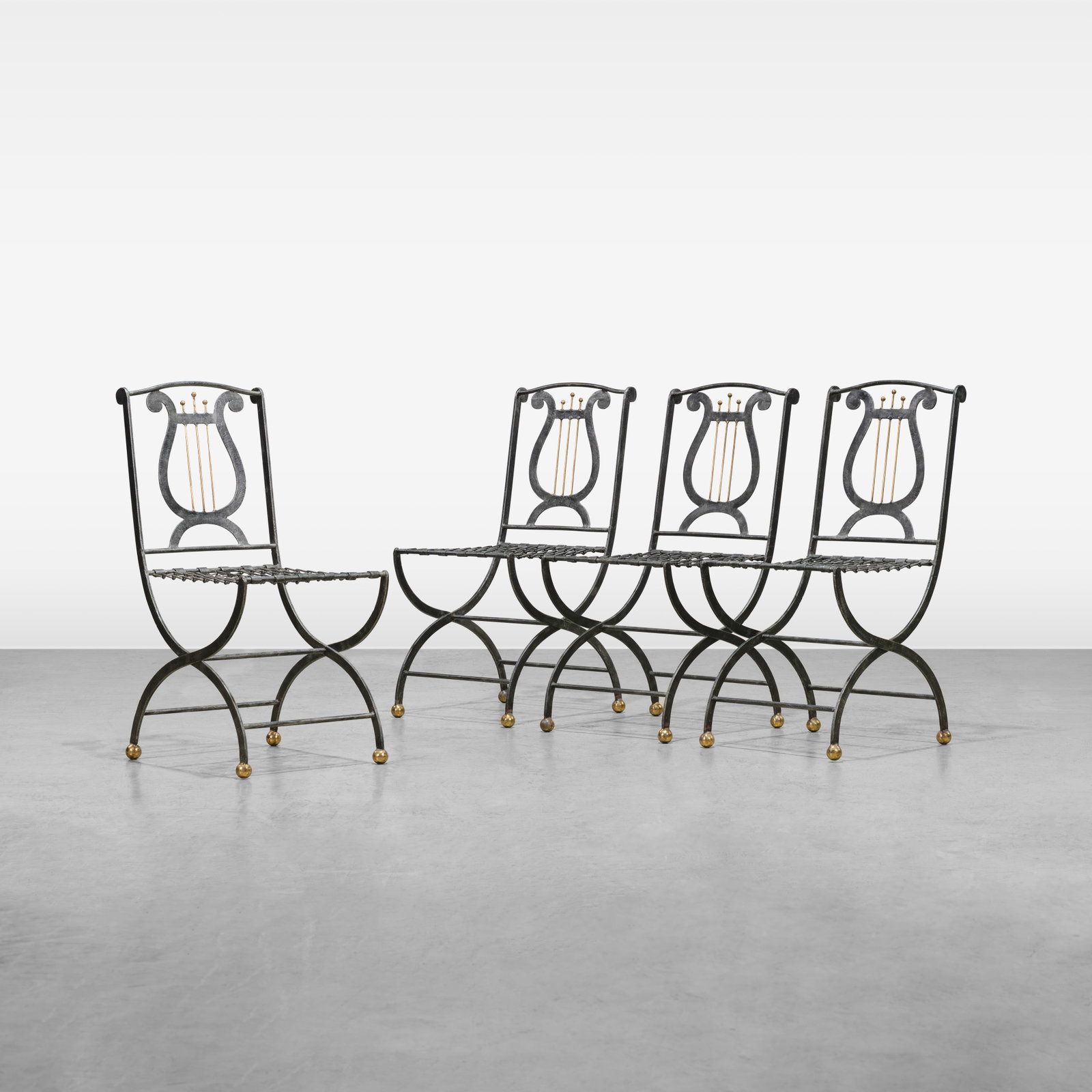 Maitland Smith - Folding Chairs: A set of four metal lyre back folding chairs with chain link seats by Maitland Smith. All measurements are in inches. Height x Width x Depth