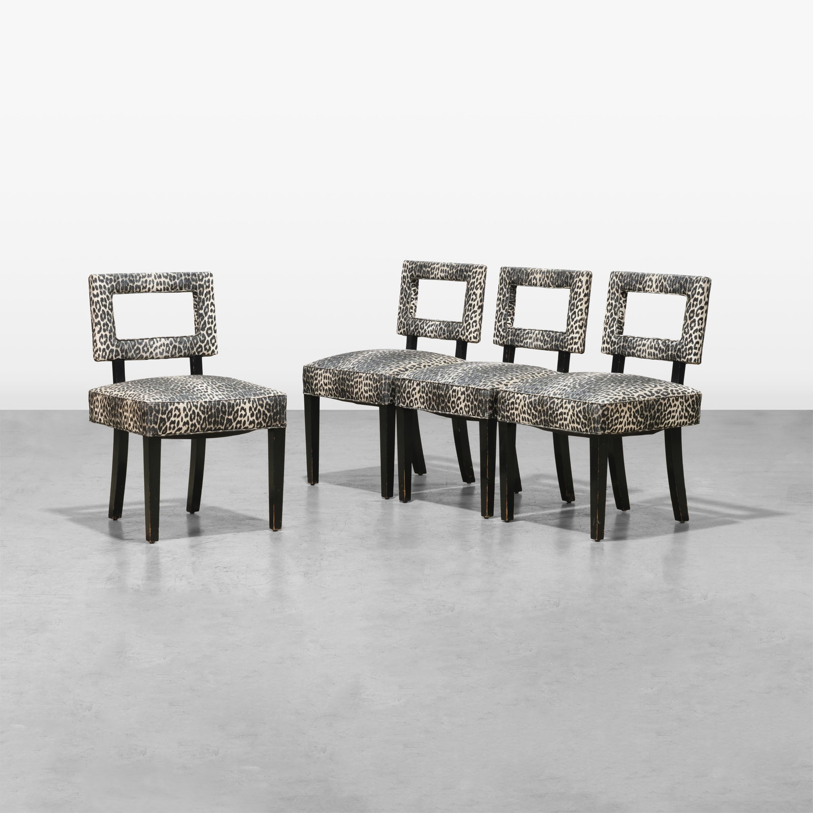 Vintage Dining Chairs: A set of four vintage dining chairs with original leopard print vinyl upholstery and open backs in the manner of Tommi Parzinger. All measurements are in inches. Height x Width x Depth