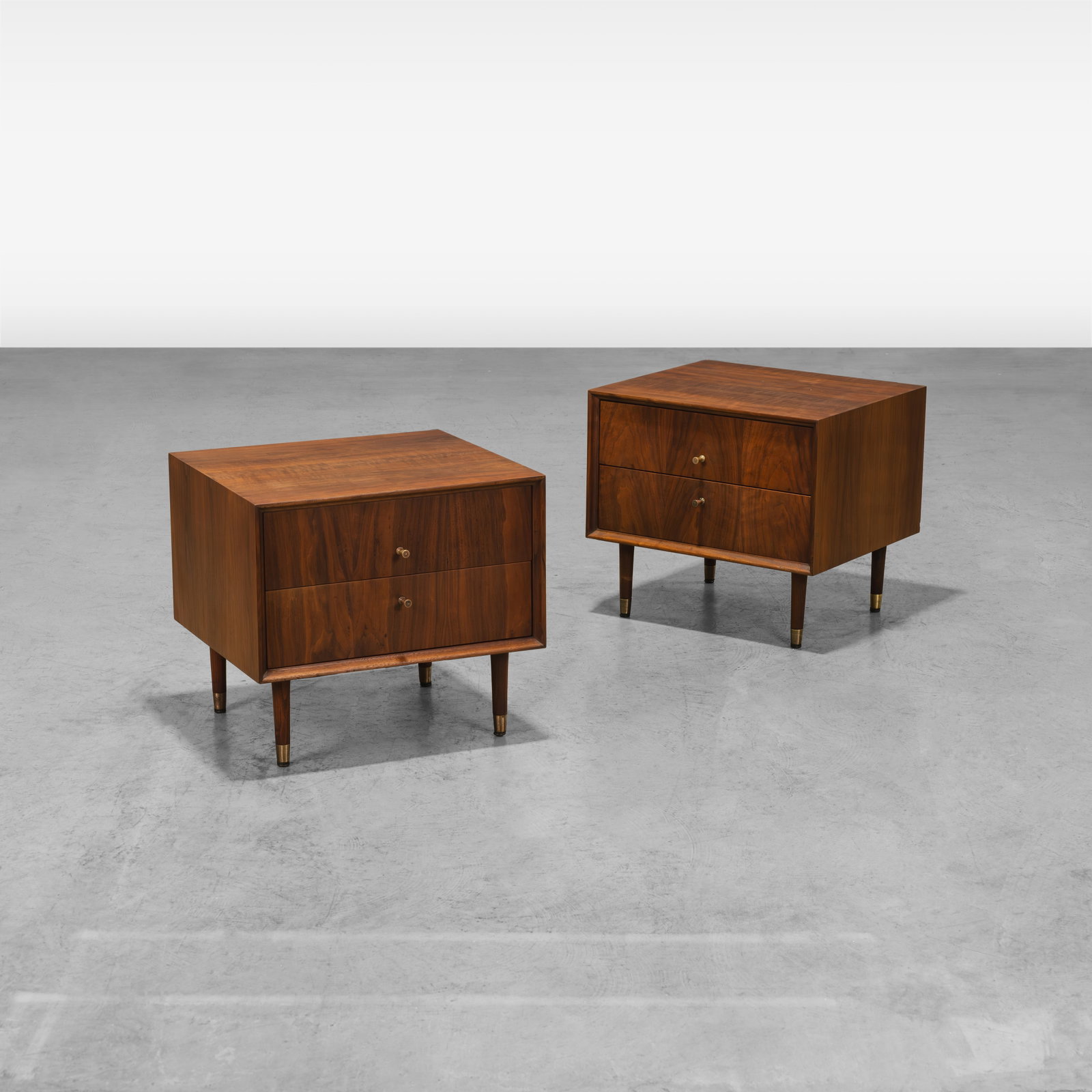 Walnut Nightstands: A pair of low walnut nightstands in the manner of Paul McCobb. All measurements are in inches. Height x Width x Depth
