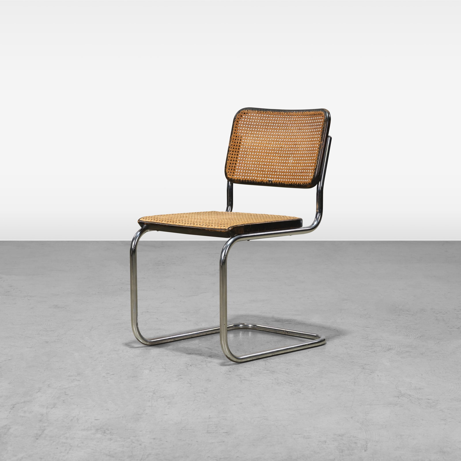 Marcel Breuer - Chair: A single cane and chrome 'Cesca' chair by Marcel Breuer. All measurements are in inches. Height x Width x Depth