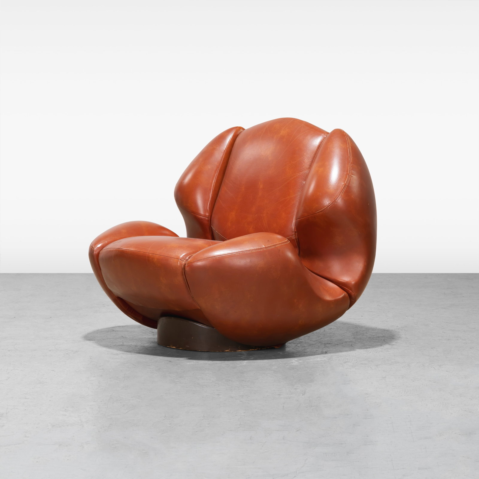 Mario Marenco - Lounge Chair: A vintage Italian leather lounge chair on pedestal by Mario Marenco for Comfortline. Chair and base are two separate pieces. All measurements are in inches. Height x Width x Depth