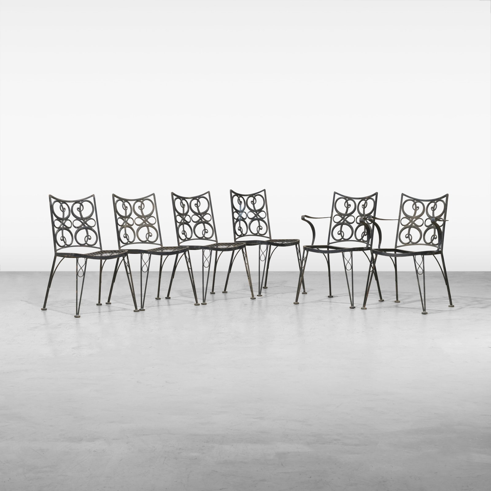 Woodard Patio Chairs: A six piece Woodard aluminum patio set consisting of four side chairs and two arm chairs. All measurements are in inches. Height x Width x Depth