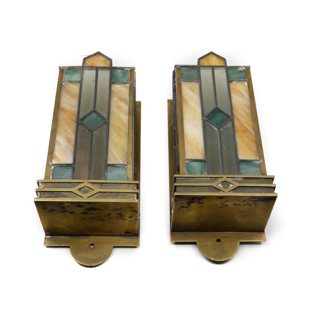 Arts and Crafts Movement Leaded Glass Sconces: Pair of Arts and Crafts Movement Brass and leaded Glass Sconces with Geometric Design. H. 12 in.; W. 4 1/2 in.; D. 3 1/4 in.