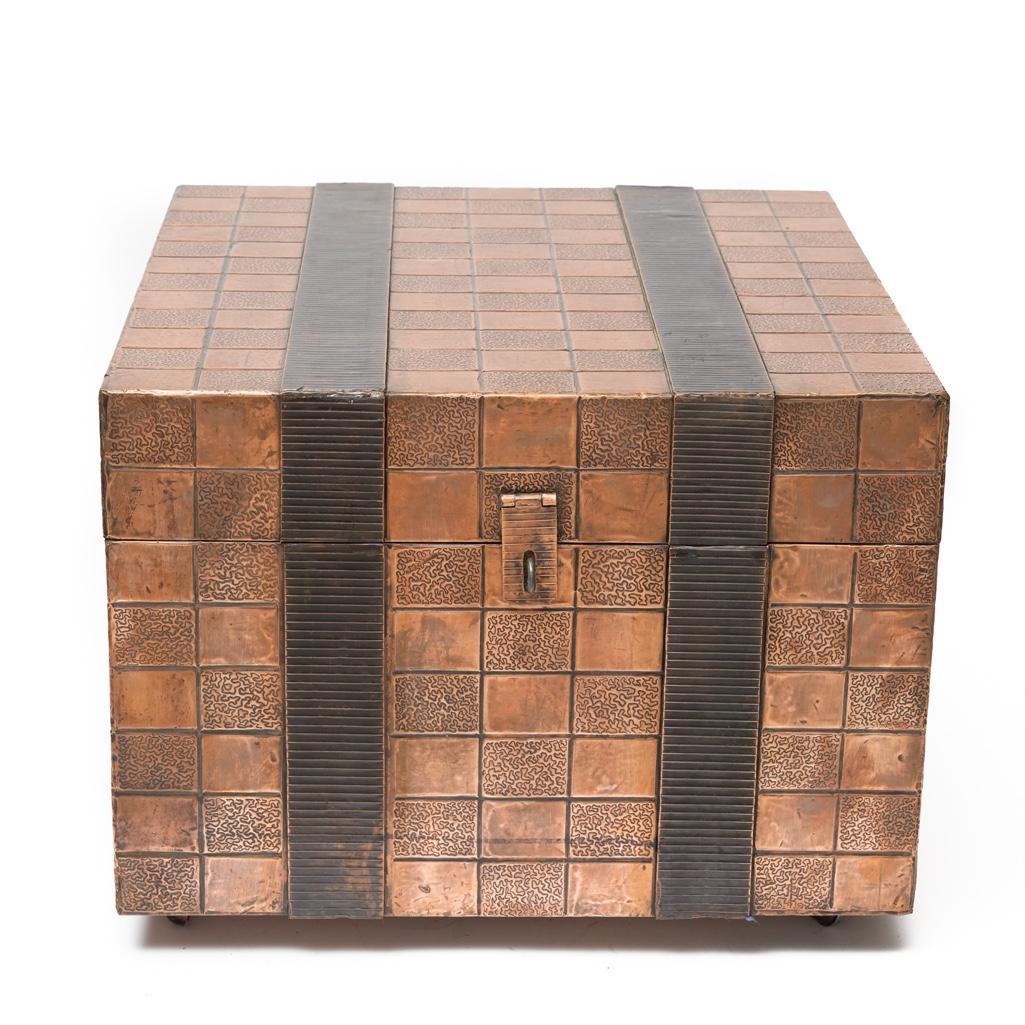 Maitland-Smith Style Copper Clad Trunk Side Table: Maitland-Smith style copper clad trunk side table with ribbed banding, hinged lid, and side handles. 18" H x 24" square.
