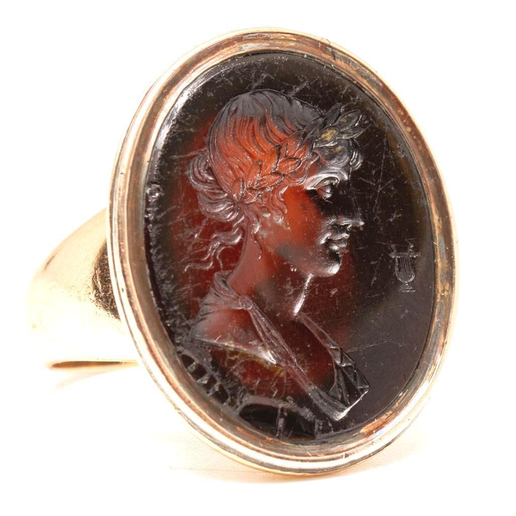 Victorian Gold and Garnet Intaglio signet Ring Circa: Victorian Gold and Garnet Intaglio Ring depicting a Goddess and Lyre. From an Estate at United Nations Plaza NY, and purchased from James Robinson 57th Street New York, NY in 1975 with original receip
