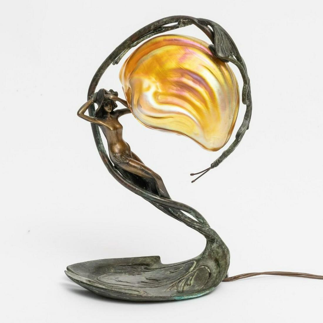 C. Bonnefond Signed Art Nouveau Figural Bronze Lamp: Claude Bonnefond Signed Art Nouveau Figural Bronze Lamp - Patinated bronze, iridescent loetz or tiffany style glass shade, signed on base. early 20th century Measures 11.5"H x 8.5"W x 5.25"D This piec