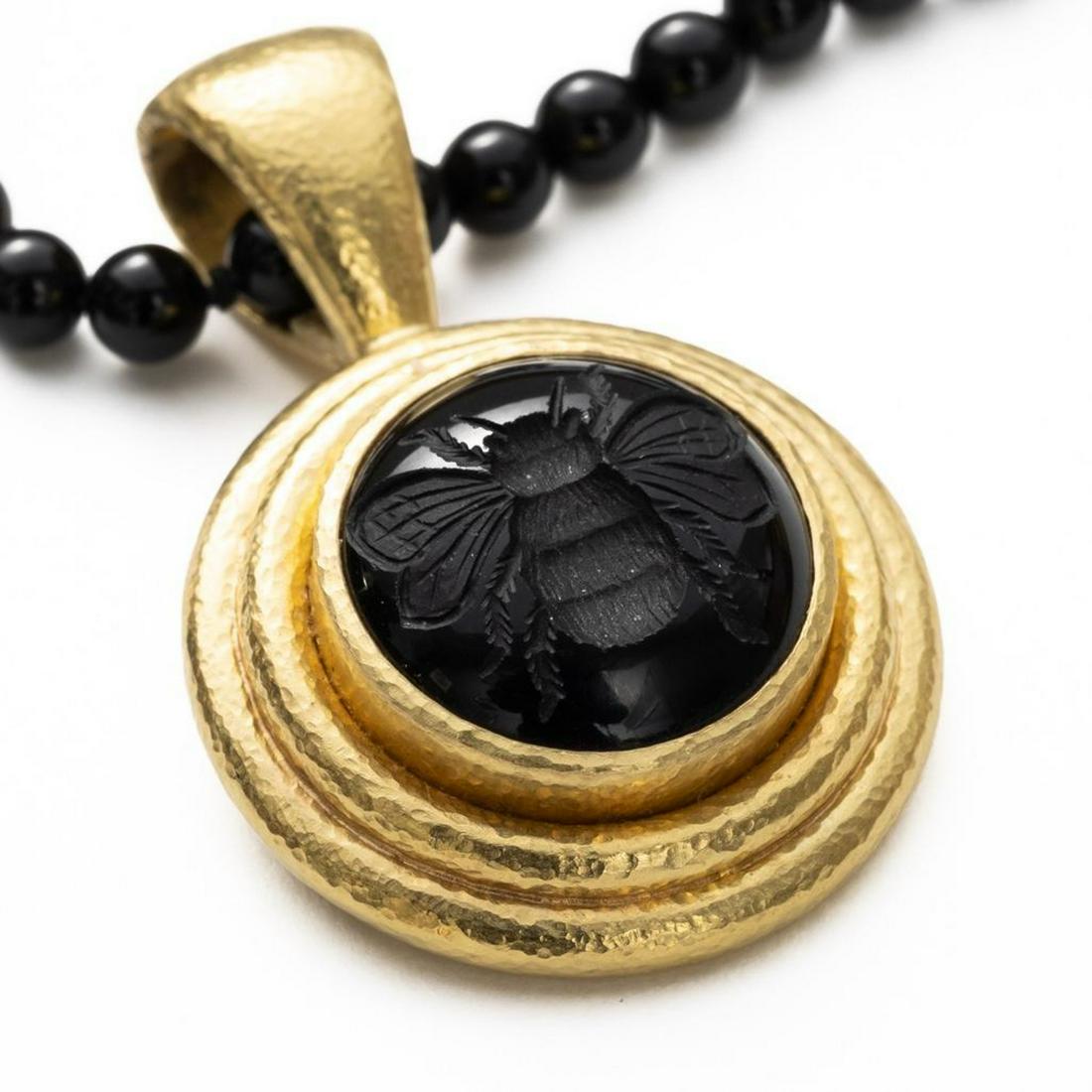 18K and Onyx Elizabeth Locke Necklace: 18K and Onyx Elizabeth Locke Necklace. Necklace measures 41" L. Pendant measures 23.6mm wide. Elizabeth Lockes jewelry started showing up in Neiman Marcus and other places around the United States in