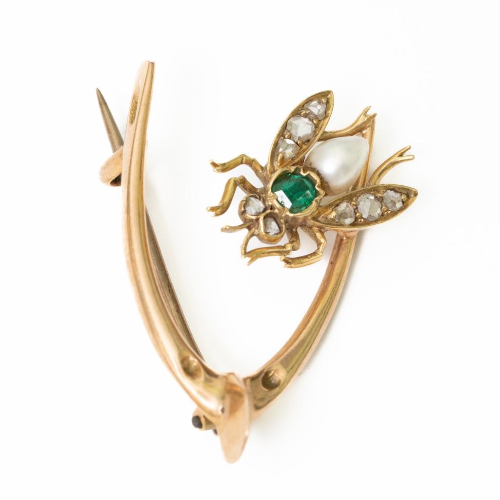 19th Century 14K gold Emerald, Pearl and Diamond Brooch: 19thc wishbone form 14K gold, Diamond, Pearl and emerald brooch. Weighs 4 grams. Measures3/4" x 1 1/8" Please paste link into browser to see video.https://youtu.be/b_9N2rOqDzs