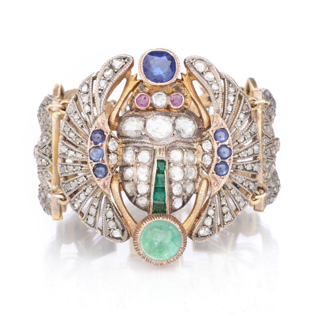 Bracelet, Early 20th century Egyptian Revival Diamond and gem-set Scarab Bracelet: Spectacular Egyptian revival Silver and gold Diamond and gem-set scarab bracelet. Centered on a scarab, set with rose-cut diamonds, rubies, emeralds, and sapphires, joining ankh and lotus links set wi