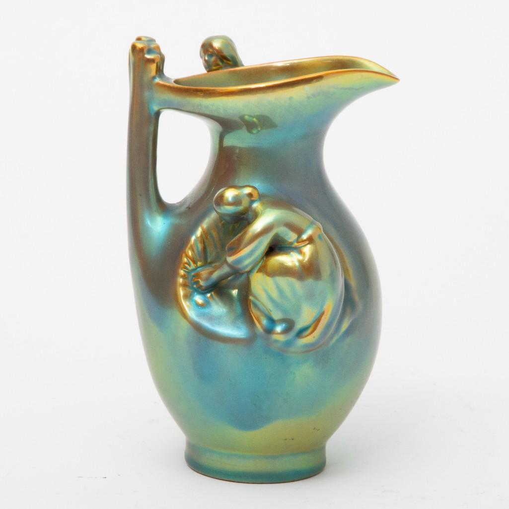 Early 20th Century Zsolnay Art Nouveau Iridescent Pitcher: Early 20th Century Zsolnay (Hungarian) art nouveau period pitcher having iridescent glaze, decorated with female figures Marked on underside of base. Dimensions: 6 1/2" high x 3 3/4" diameter at wides