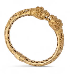 Ilias Lalaounis or Zolotas 18K Yellow Gold Lion Chimera Bangle Bracelet: Ilias Lalaounis or Zolotos 18K Yellow Gold Lion Chimera Bangle Bracelet With opening branches, it is chiseled with ornamental patterns, ending with two facing lion heads.&nbsp; Total gross weight: 35.