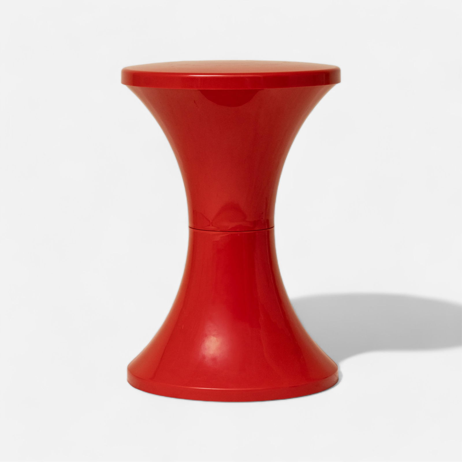 Tam-Tam Stool Red By Hanery Massonnet: Tam-Tam Stool Red By Hanery Massonnet A small, ergonomic, and comfortable stool with hidden storage underneath the seat. The stool's shape is inspired by a drum: in French "tam-tam" refers to a tambou