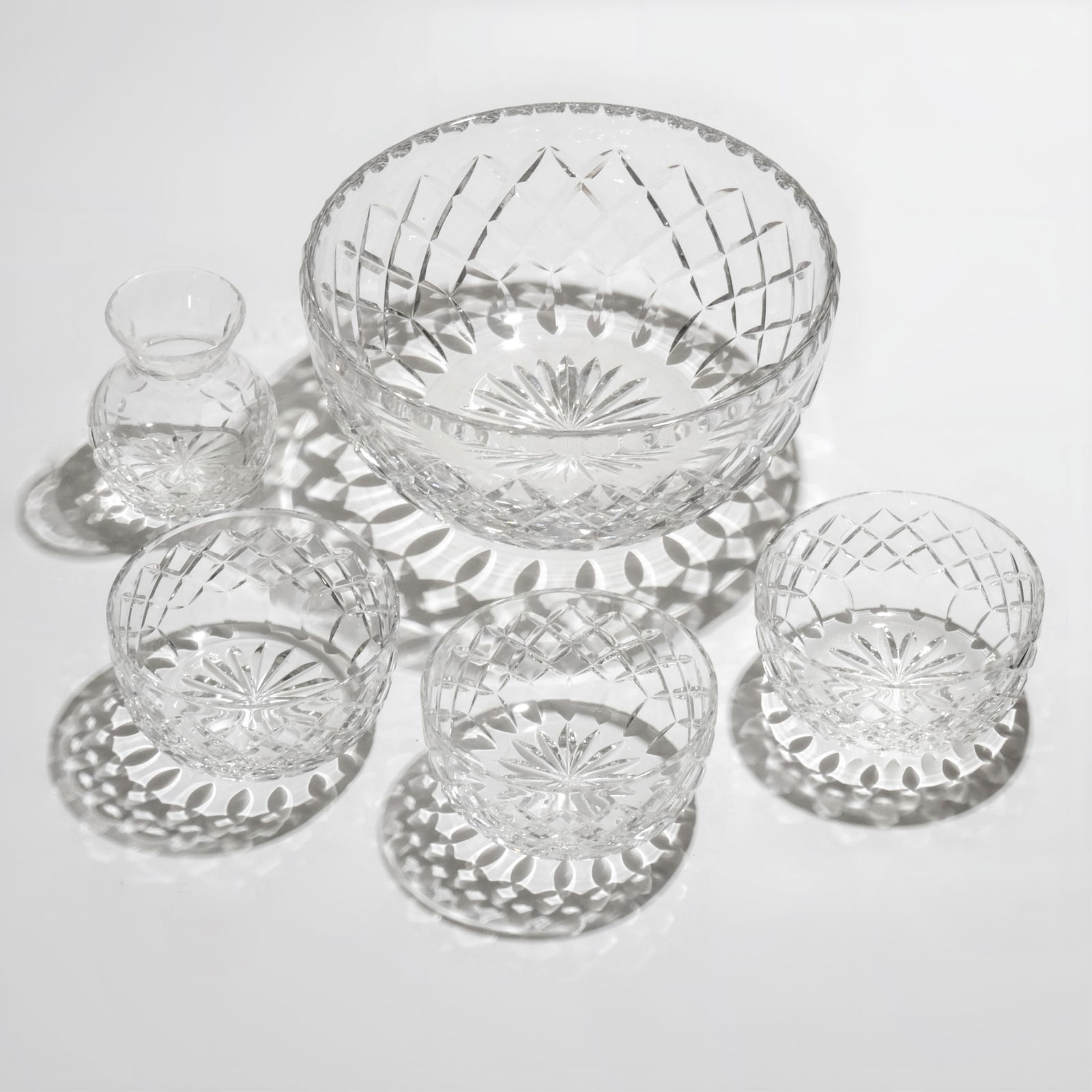 Cartier Cut Crystal Glass 5-Piece Lot all are signed: Keywords: luxury glassware, diamond lattice pattern, starburst foot, clear lead glass, centerpiece bowl, dessert service, small bud vase, tableware, barware, modern classic, giftware, etched signature