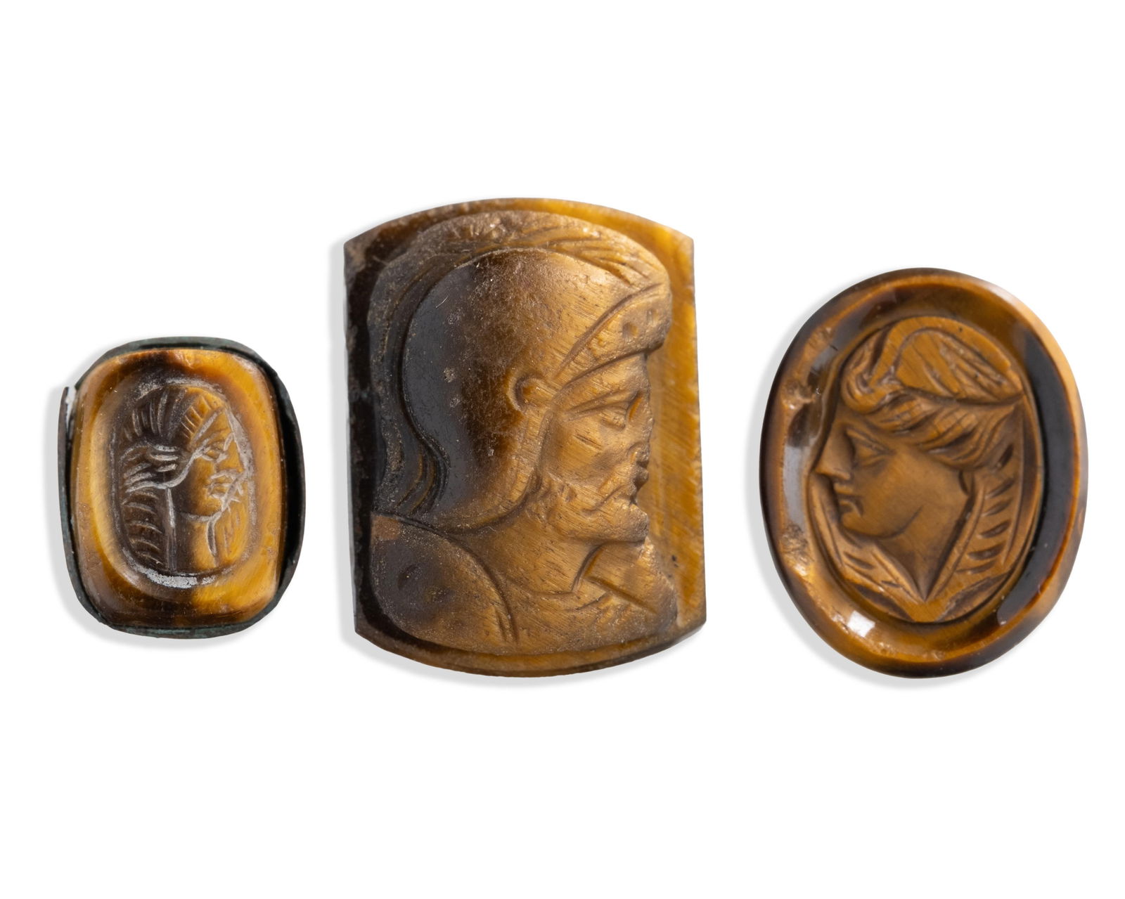 Group of Three Antique Tiger’s Eye Intaglio Cameos, Classical Profiles: Keywords: hardstone carving, classical intaglio, Roman style, engraved gemstone, ancient revival, Greco Roman profile, figural carving, lapidary work, collectible antiquities style, seal stone,