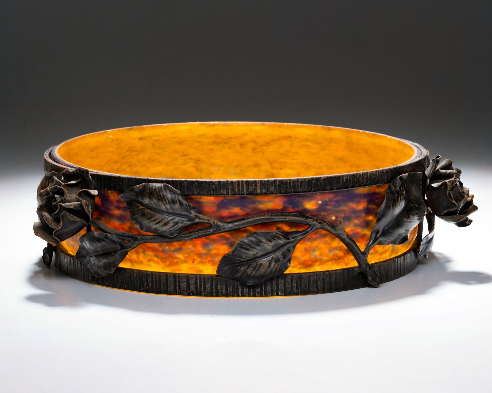 Art Deco Wrought Iron & Glass Center Bowl, c. 1930: Keywords: No reserve, Edgar Brandt, Paul Kiss, French, fer forgé, patinated, rose motif, floral garland, forged leaves, marbled amber, translucent liner, centerpiece, interwar period, modernist decor