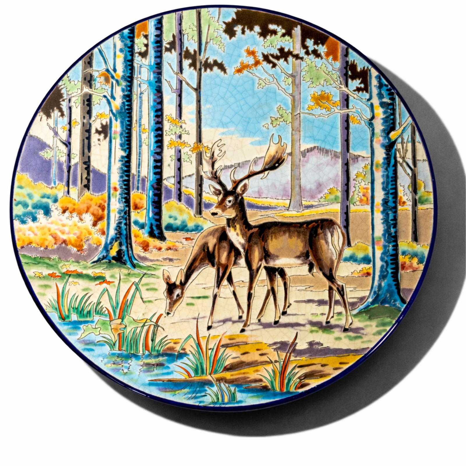 Longwy Artist signed Limited Edition “Clairiere" Enamel Charger: Keyword: Longwy, France, art pottery, Atelier d’Art, Clairiere, faience, crackle glaze, round charger, wall plaque, stag and doe, forest landscape, limited edition, signed Thirgnon, rehausse PH, wil