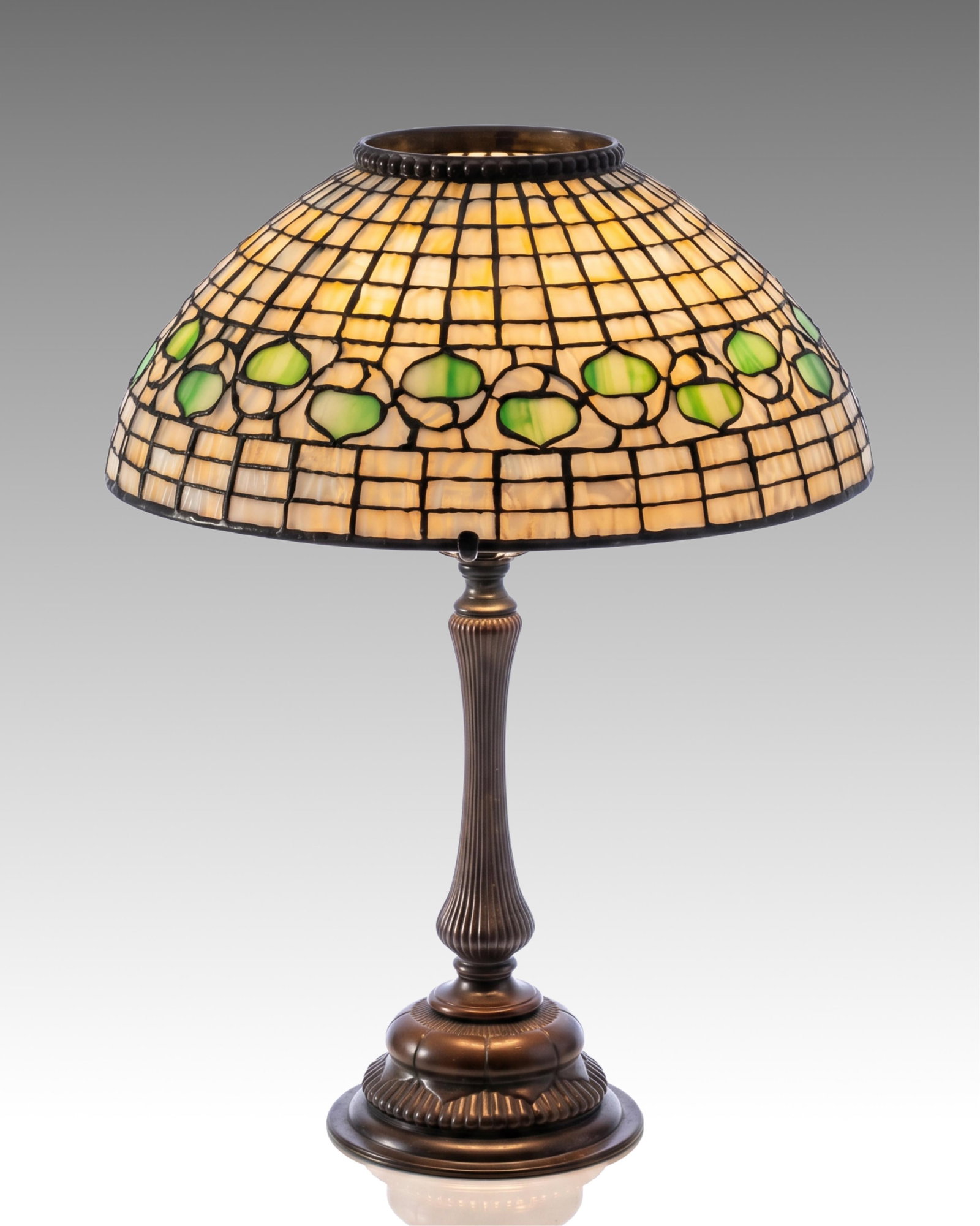 Tiffany Studios New York Acorn Leaded Art Glass Table Lamp on a Rare Three-Light Bronze Base: Keywords: Louis Comfort Tiffany, Art Glass, Early 20th Century Glass, bronze table lamp, American decorative arts, antique lighting, rare Tiffany Summary: Tiffany Studios New York Acorn Art Glass tabl