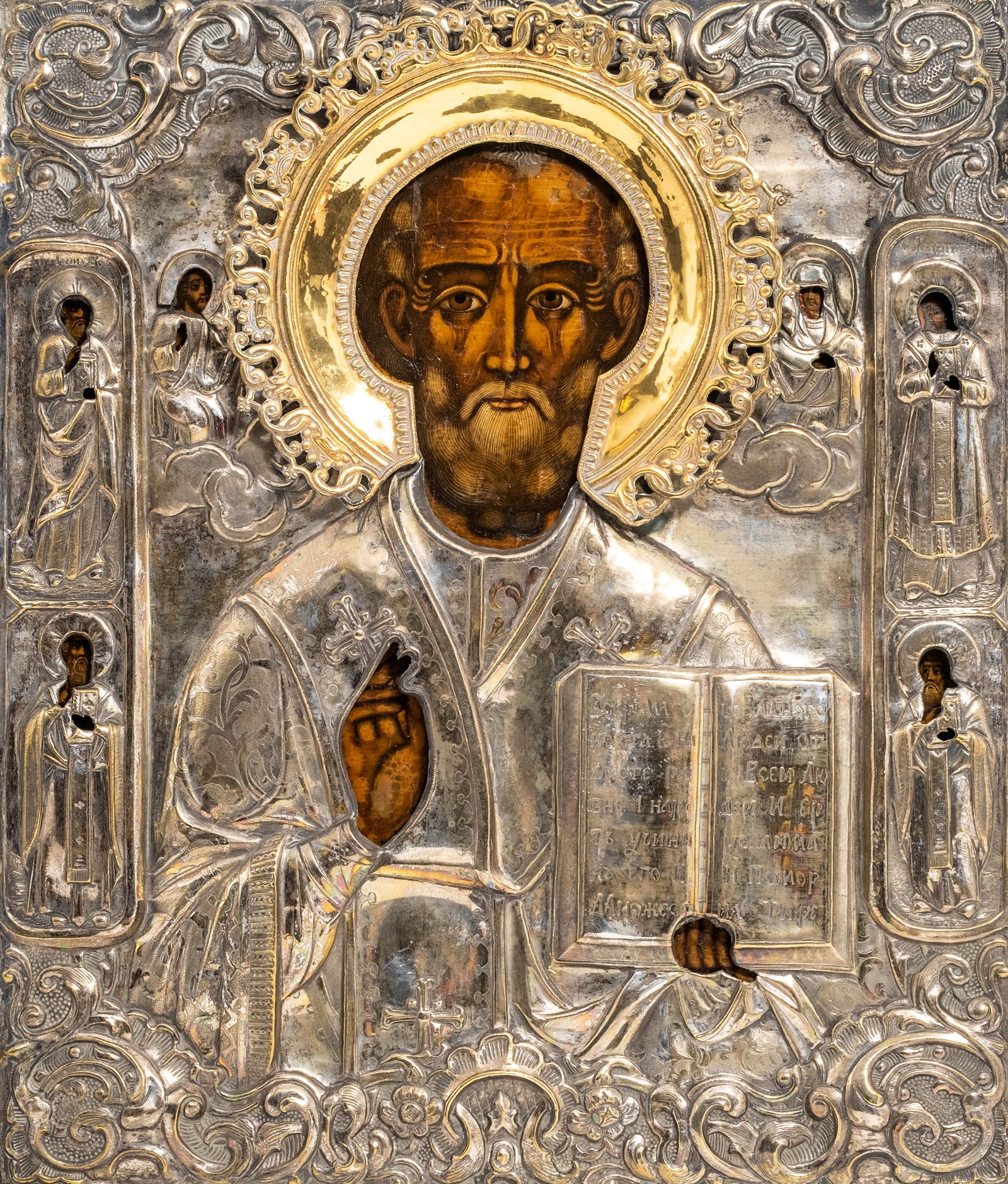 Early 19th Century Russian Orthodox St. Nicholas Icon with Silvered Brass Oklad: Keywords: Russian Icon, St Nicholas, Orthodox Icon, Imperial Russia, Silvered Brass, Oklad, Riza, Repousse, Religious Art, Devotional Art, Wood Panel, Gilt Halo, Selected Saints Summary: Early 19th ce