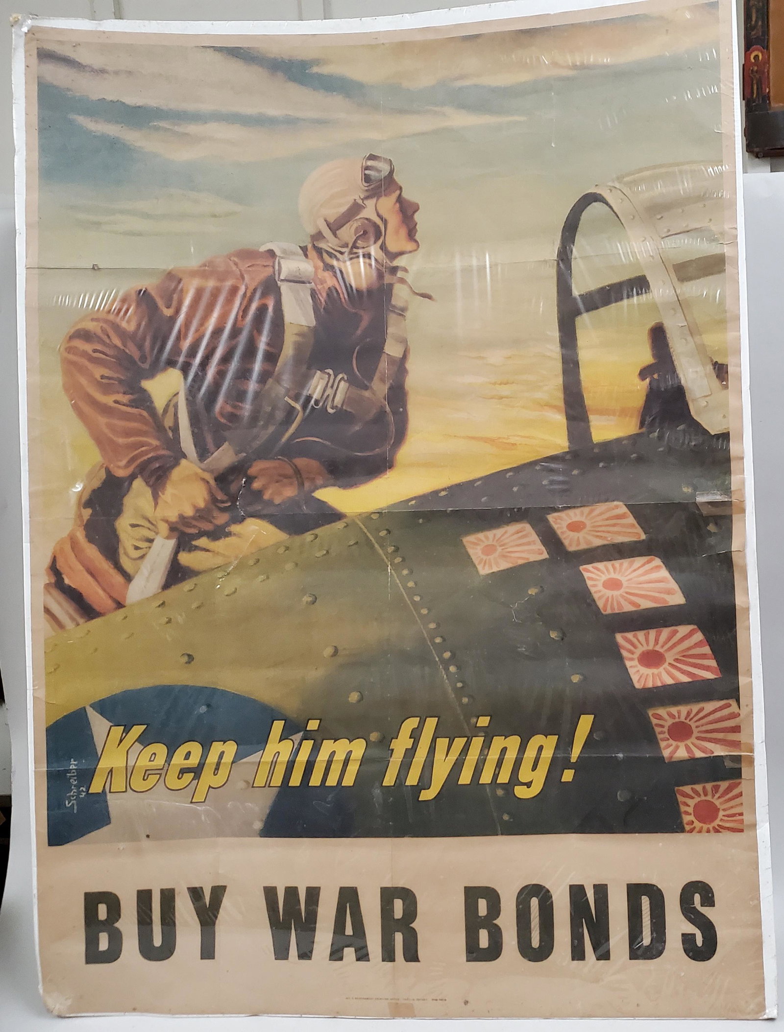 World War II Poster: World War II Poster, with Airman and the caption: KEEP HIM FLYING, BUY WAR BONDS, original lithograph signed by the artist, dated 1943, Government Printing Office. 38 1/2 x 29 inches, currently under 