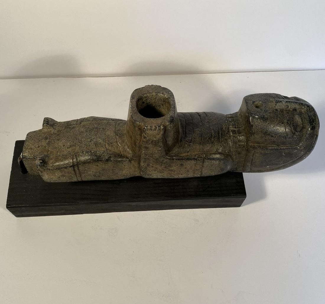 Native American Stone Smoking Pipe Humanoid Shape: A large carved grey color stone Native American smoking pipe set on a stand, a remarkable object with a great presence for its unusual size, with original patina, 19 th c. or earlier. 12 in. long by 2