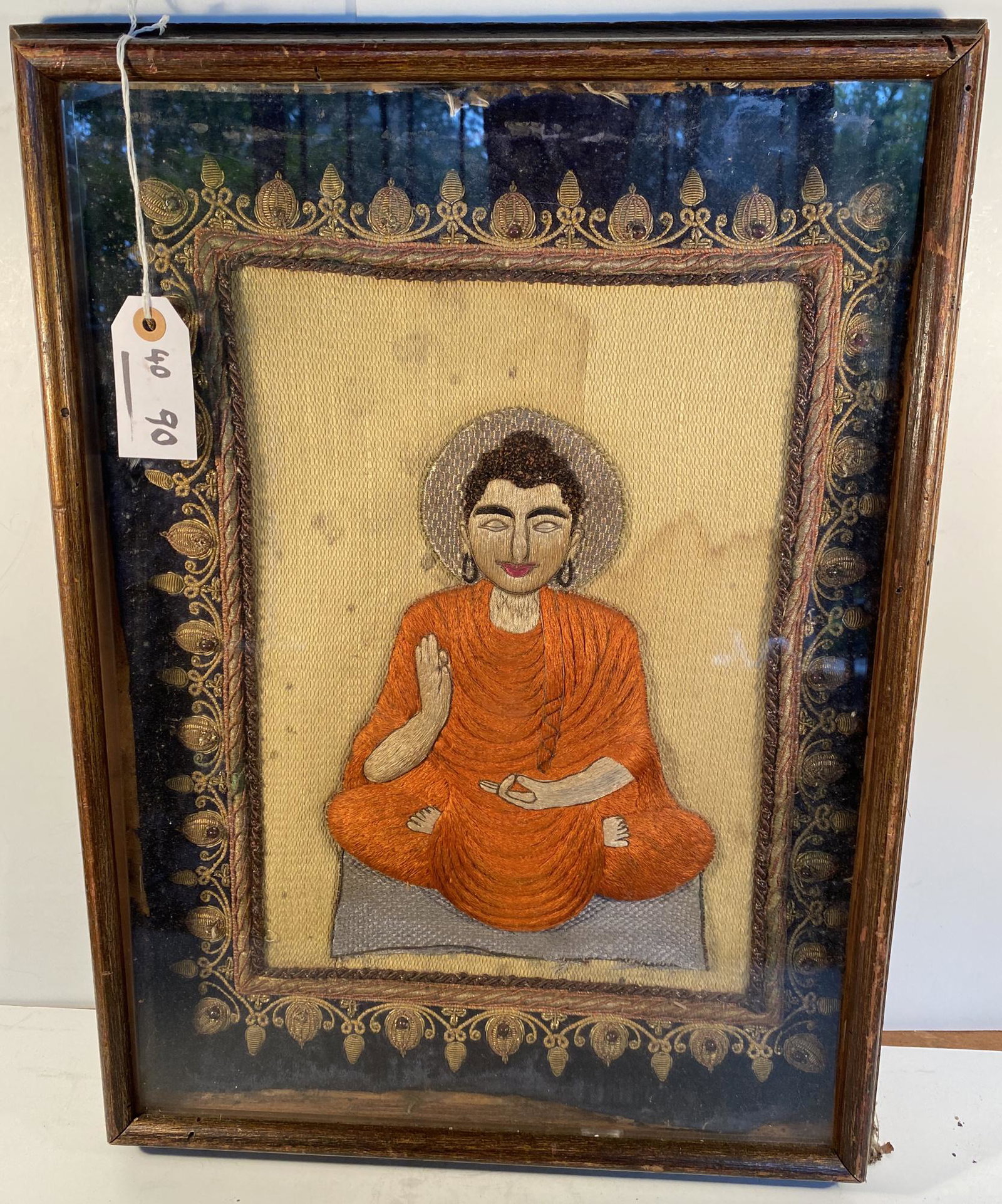 Burmese Textile of Buddha: A rare Burmese textile of the Great Buddha with fine stitch work using gold thread contained in a frame 21 ½ in. x 16 in. overall