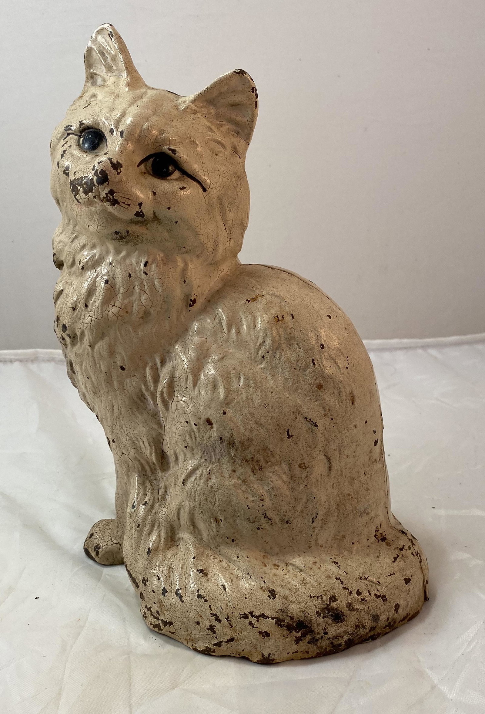 Cast Iron Cat Doorstop: A cast iron antique door stopper in the form of a cat. Cast in two parts, marked Hubley. 8 ¾ in. x 7 in.