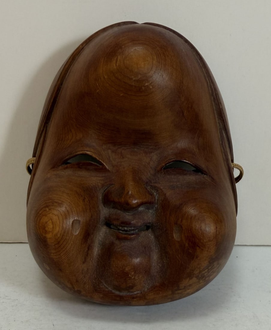Japanese Carved Wood Okame Mask: Length: 4 1/4 inches, Width: 3 3/8 inch, Depth: 2 3/8 inches. Weight: 2.2 oz.
